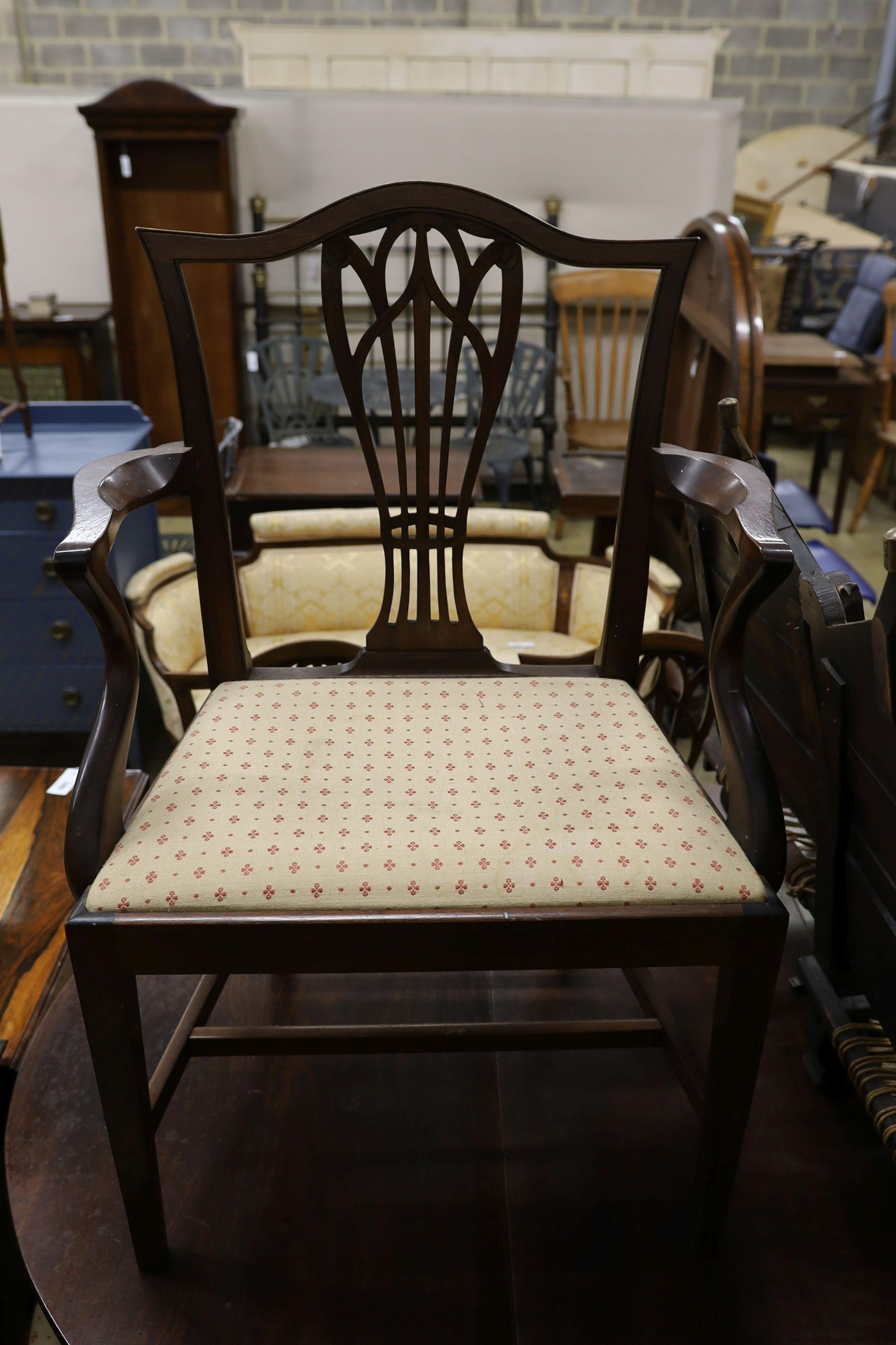 A set of nine George III and later mahogany dining chairs with pierced splats and upholstered drop in seats (six antique three reproductions, one with arms)
